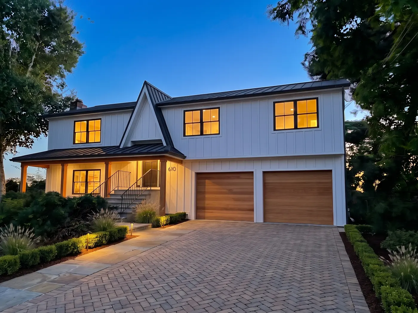 The same house as a modern farmhouse at twilight